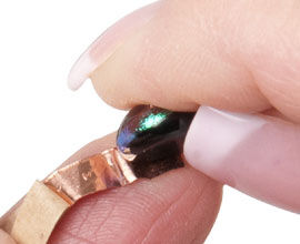 Foil being wrapped around cabochon
